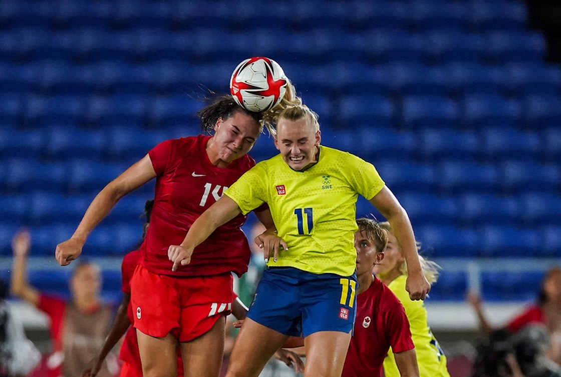 Vanessa Gilles and a Swedish player both go for a header on the ball
