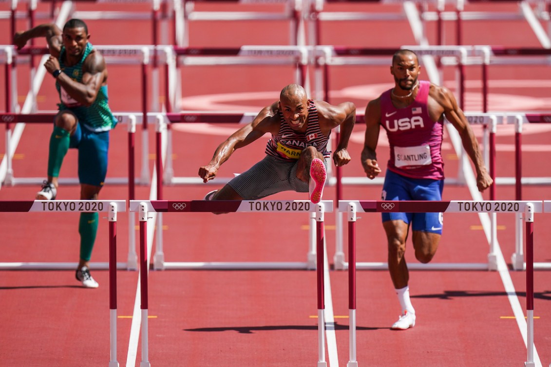 Damian Warner races over the 110-metre hurdles in the decathlon.