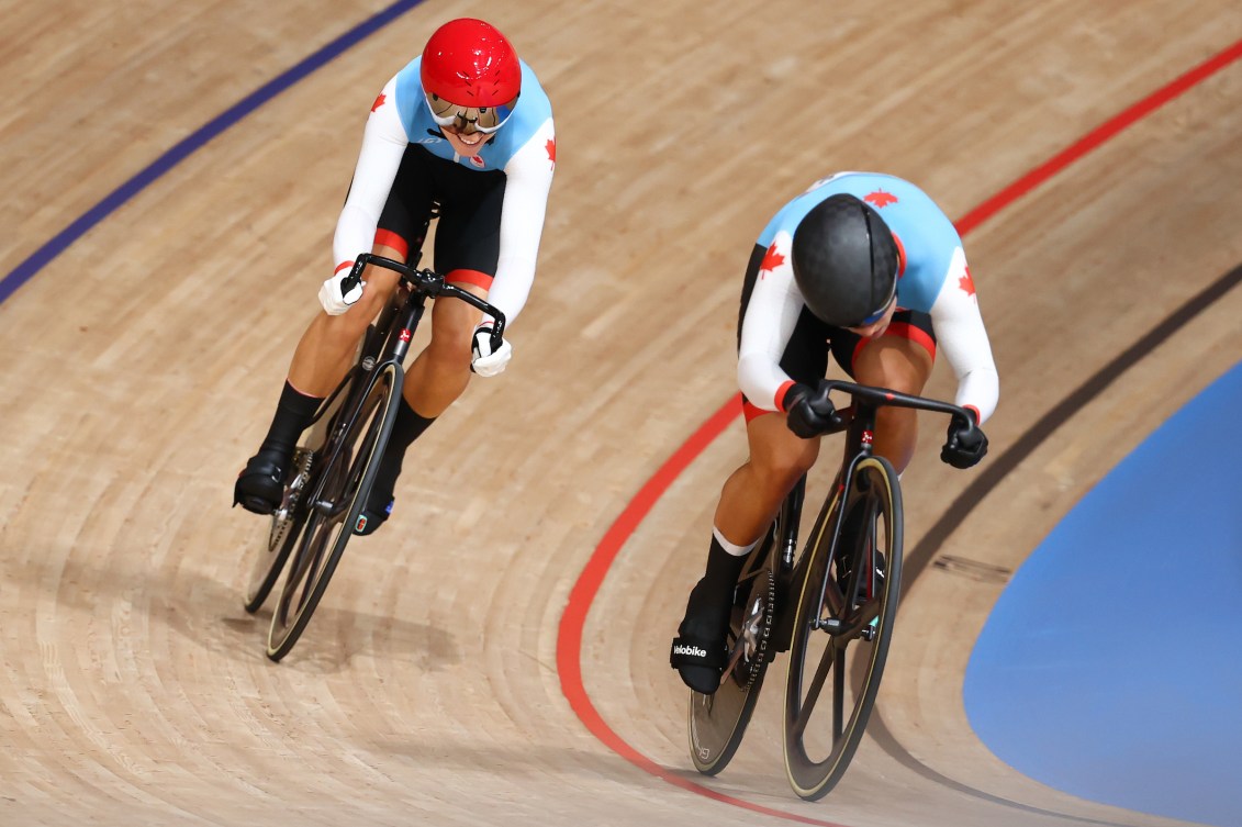 Kelsey Mitchell and Lauriane Genest race against each other in the track cycling sprint 