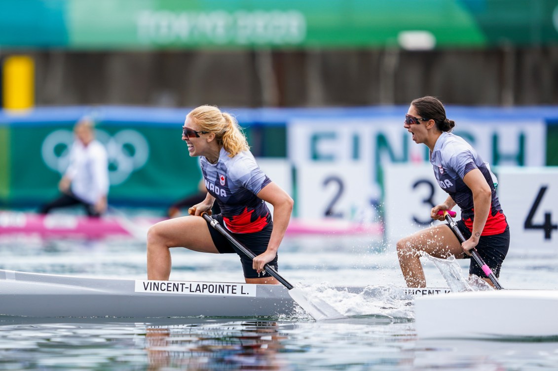 Laurence Vincent Lapointe and Katie Vincent smile in their canoe after winning bronze 