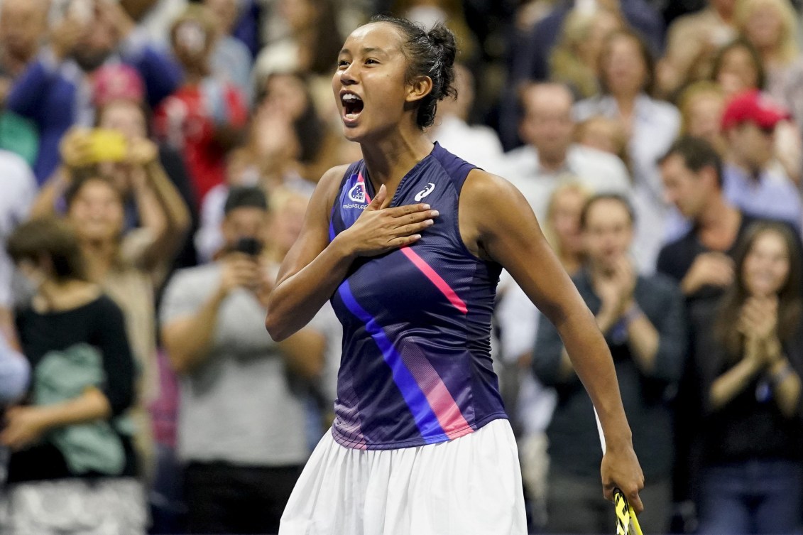 Leylah Fernandez taps her hand to her chest in celebration after a win