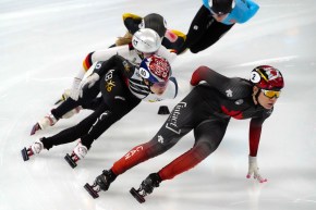 Choi Min-jeong of South Korea, left, and Courtney Sarault of Canada compete in a heat of the women's 1000m at the ISU World Cup Short Track speed skating competition, a test event for the 2022 Winter Olympics, at the Capital Indoor Stadium in Beijing, Friday, Oct. 22, 2021. (AP Photo/Mark Schiefelbein)