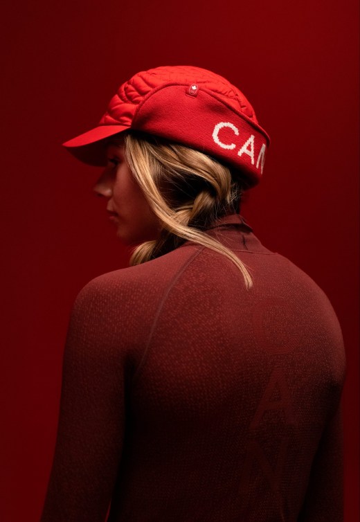 Back shot of Brooke d'Hondt in a red sweater and hat