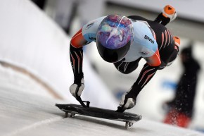 Mirela Rahneva dives onto her sled at the start of a skeleton race