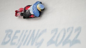 Blake Enzie slides past Beijing 2022 on ice track in skeleton race
