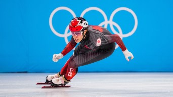 Florence Brunelle skates past Olympic rings in short track