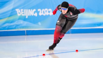 Maddison Pearman skates a curve in a speed skating race
