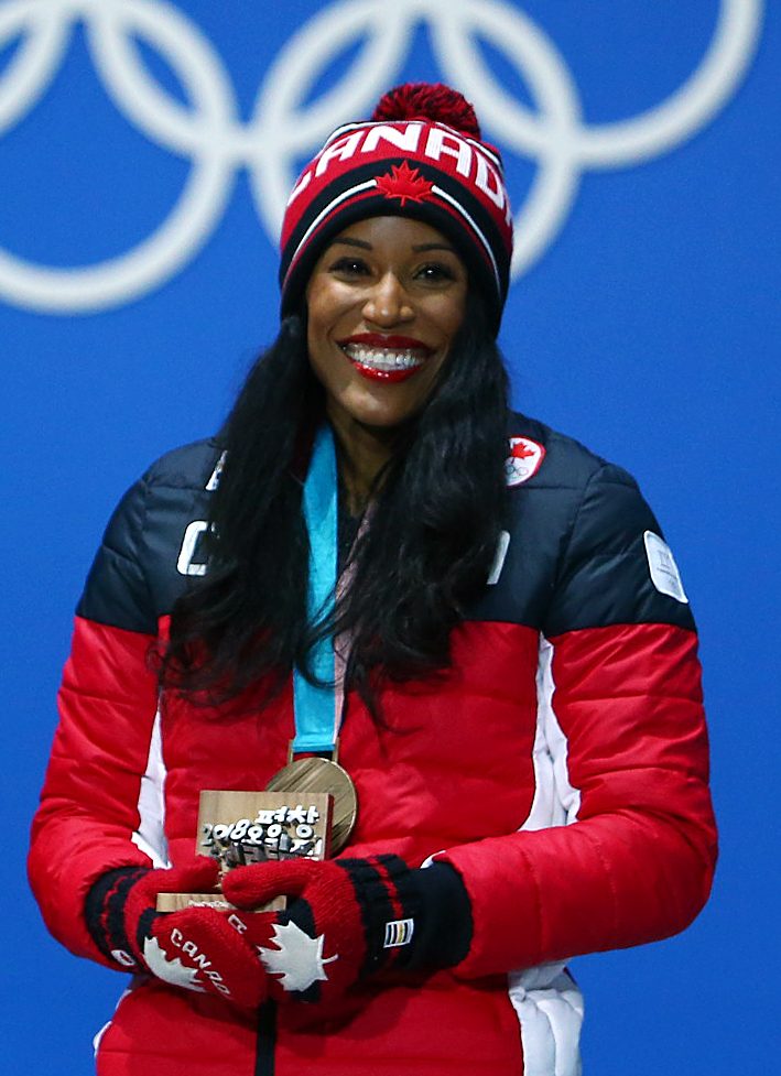 Phylicia George smiles while wearing her Olympic bronze medal 