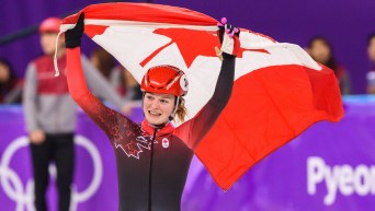 Kim Boutin holds up a Canadian flag as she finishes 2nd in at the Short Track Speed Skating -Women's 1000m Final at the PyeongChang 2018 Winter Olympic Games at Gangneung Ice Arena on February 22, 2018 in Pyeongchang-gun, South Korea