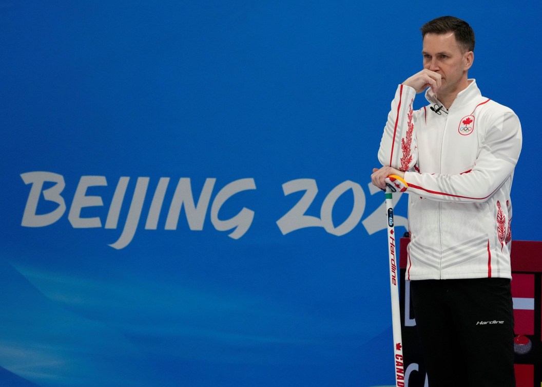 Brad Gushue leans on his broom 