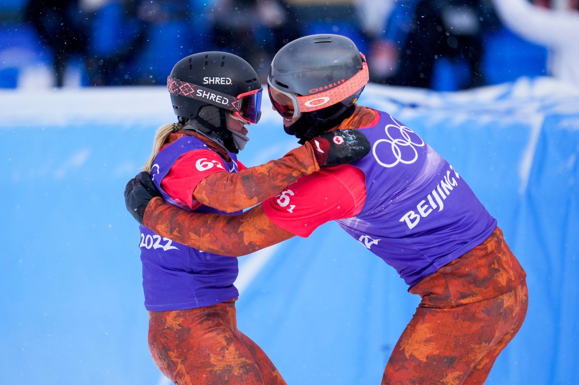 Eliot Grondin and Meryeta O'Dine hug after winning bronze