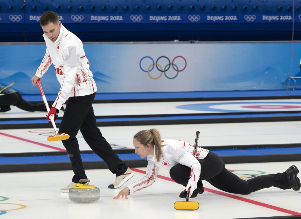 Rachel Homan throws a stone as John Morris sweeps