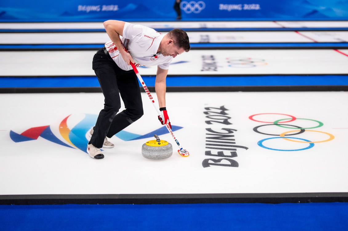 John Morris sweeps a stone