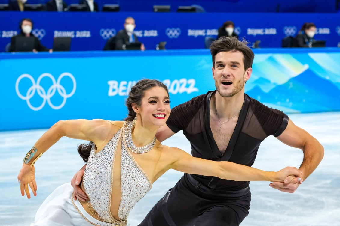 Laurence Fournier Beaudry and Nikolaj Soerensen skate in dance hold 