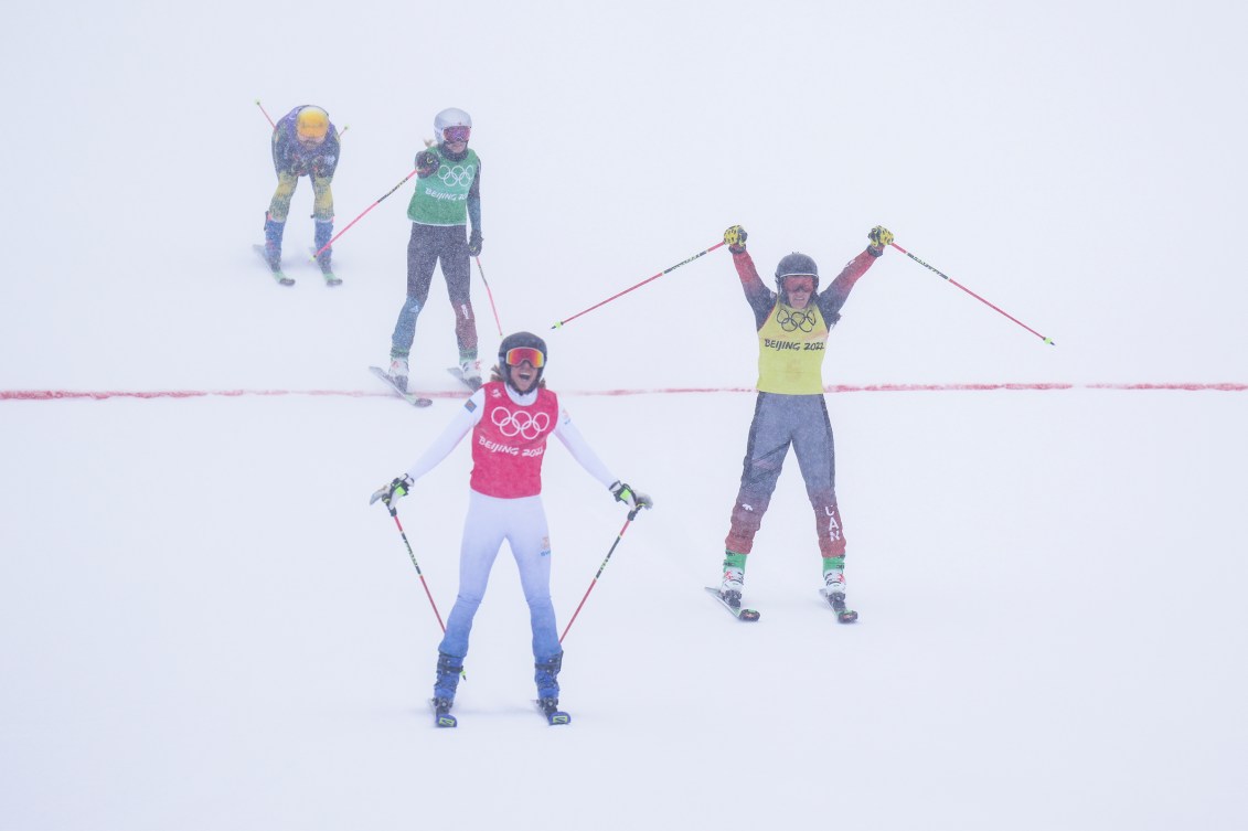 Marielle Thompson crosses the finish line and raises her arms in celebration