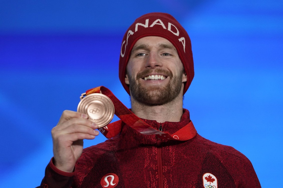 Max Parrot holds his bronze medal on the podium