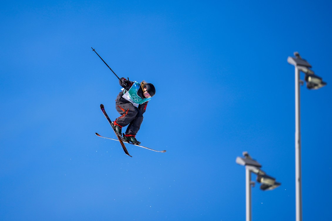 Megan Oldham grabs her ski while performing an air trick 