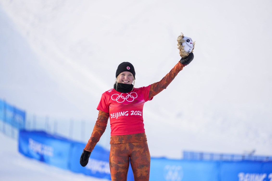 Meryta O'Dine holds up the mascot toy on the podium