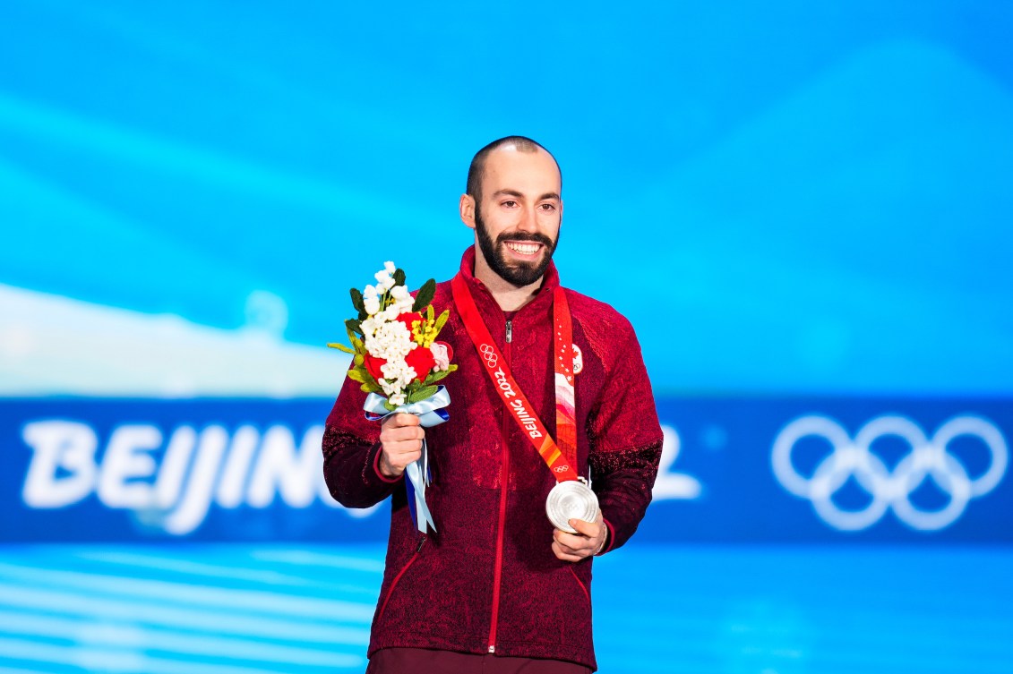 Steven Dubois wears his silver medal on the podium