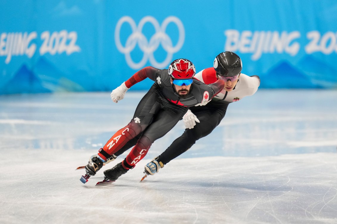 Steven Dubois races another skater in a short track race