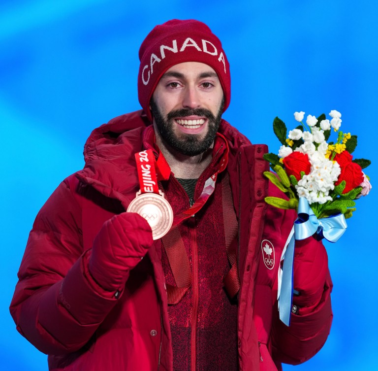 Steven Dubois wears his bronze medal on the podium