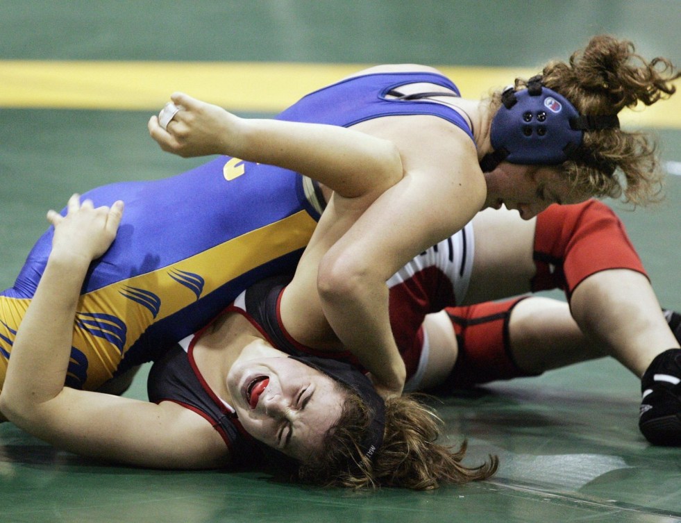 Emma Brightwell of Guelph, Ont. grimaces as she is pinned down by Leah Callahan of MacKenzie, British Columbia, during a women's tag team fight in Regina, Saskatchewan on Wednesday August 17, 2005. (CP PHOTO/Fred Chartrand)