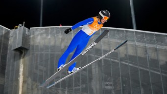 Side angle of Abigail Strate in the air while ski jumping