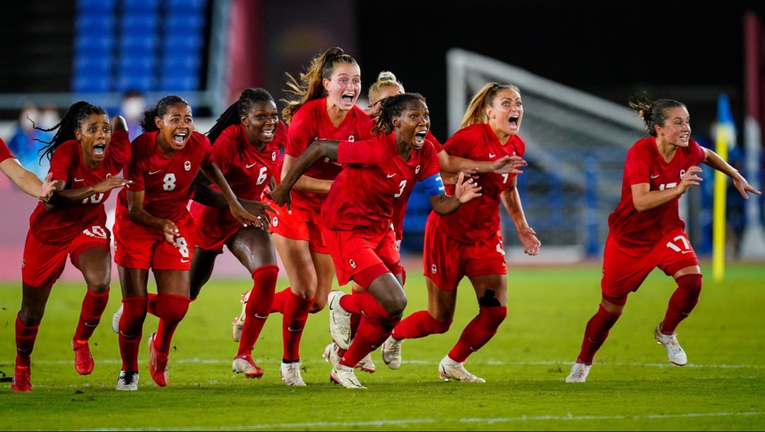 Canadian women's soccer team runs onto the field in celebration