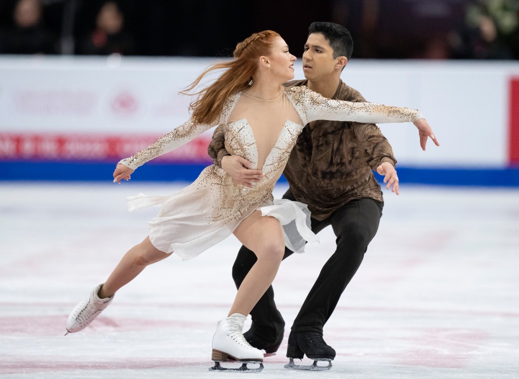 Marjorie Lajoie in a white dress and Zachary Lagha in a brown shirt perform their free dance 