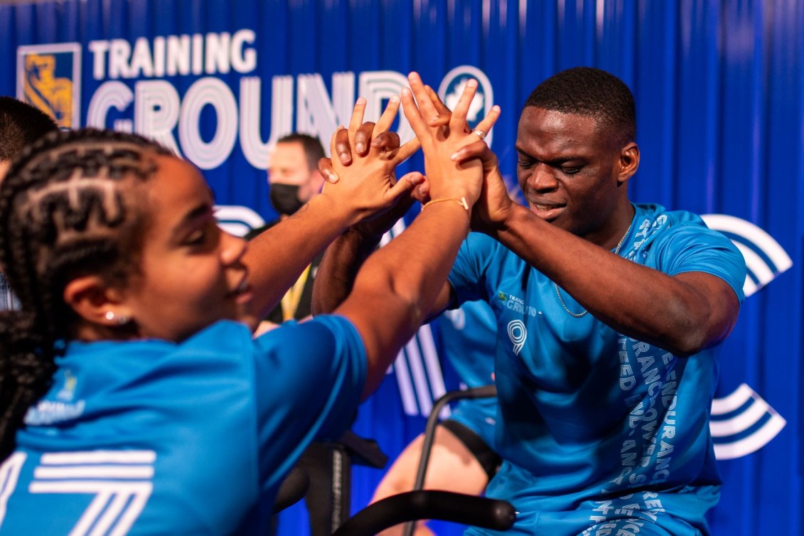 Two athletes give each other a high five after a test at RBC Training Ground