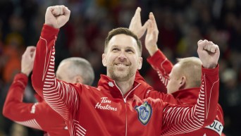 Brad Gushue pumps his arms in celebration