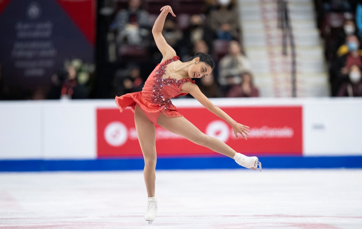 Madeline Schizas performs a spin with one leg stretched out from her body