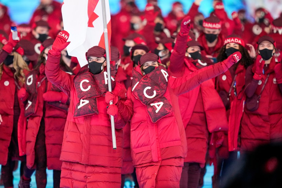 Canadian flag-bearers Charles Hamelin and Marie-Philip Poulin lead Team Canada into the opening ceremonies to officially start the Beijing 2022 Olympic Winter Games