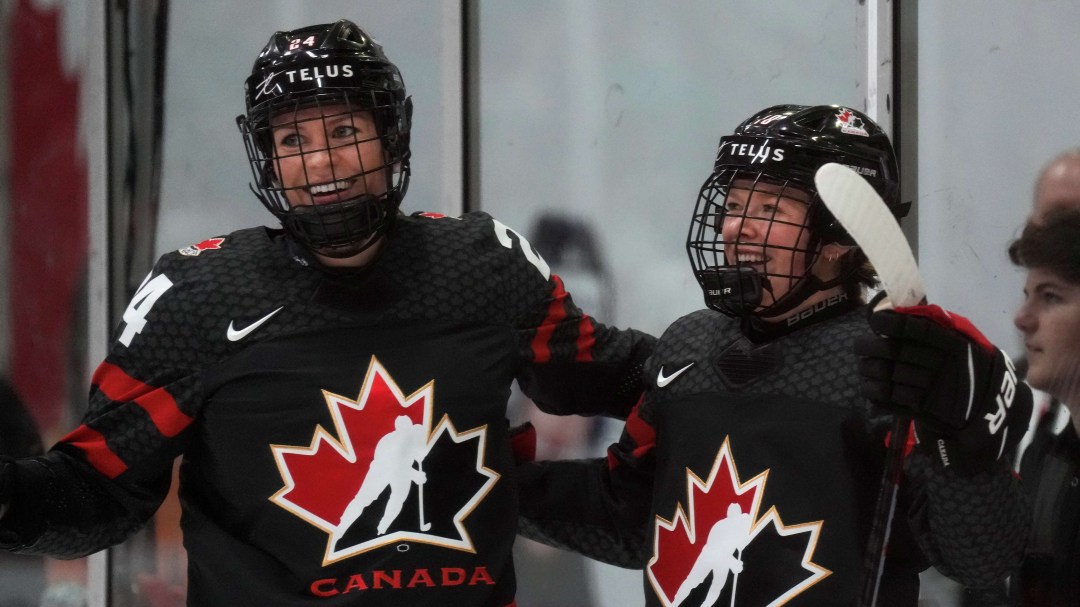 Natalie Spooner and Sarah Fillier hug each other to celebrate a goal