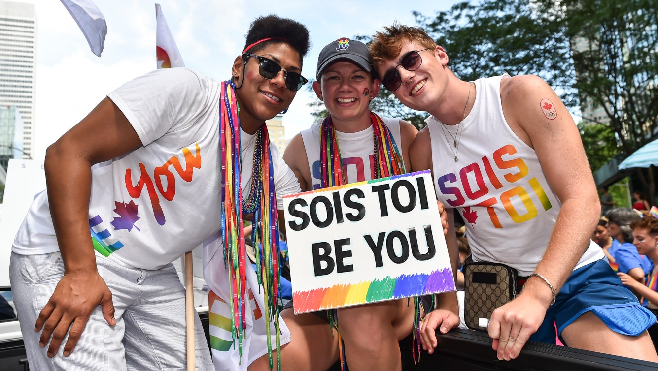 Three people participate in Calgary Pride Parade on Sunday, September 1, 2019 in Calgary (Photo: Leah Hennel/COC)