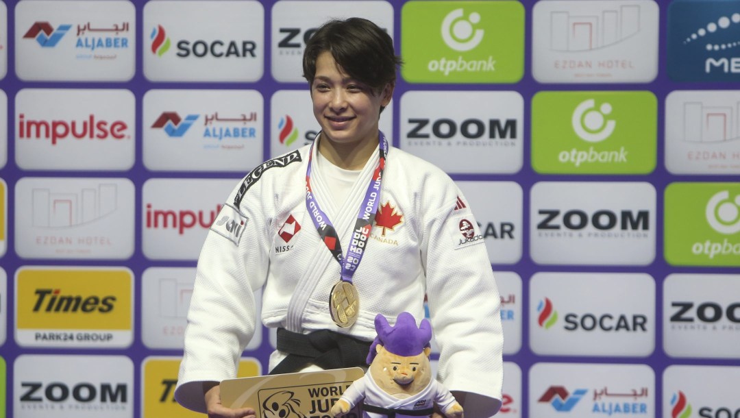 Christa Deguchi smile on the podium with the gold medal.
