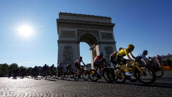 Many road cyclists race past the Arc de Triomphe during the Tour de France, road cycling's most famous Grand Tour