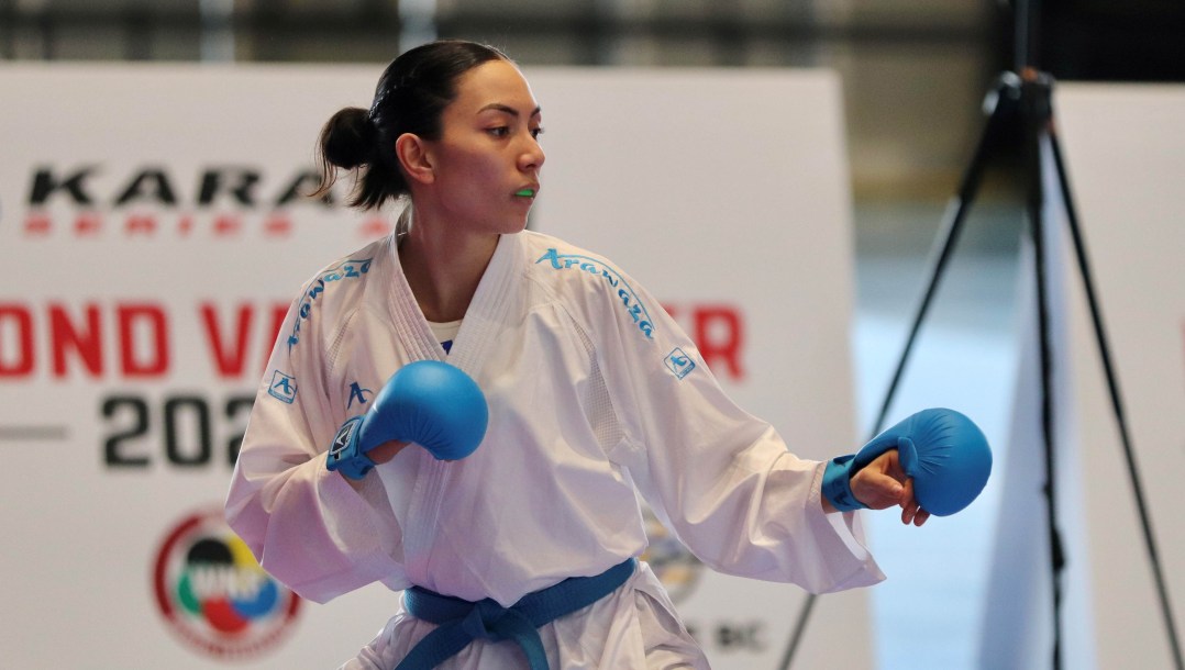 Hana Furumoto-Deshaies prepares to punch an opponent in a karate bout