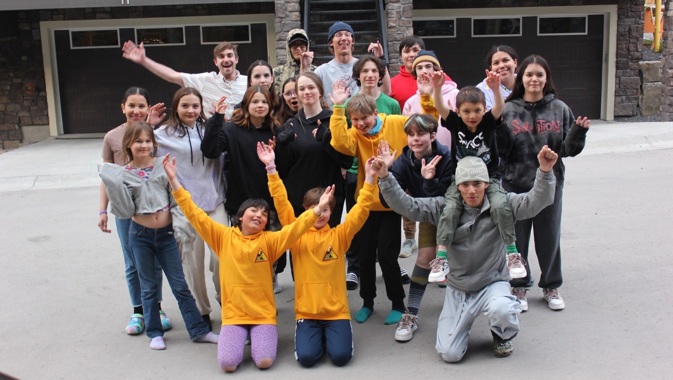 Liam Gill poses with a group of Indigenous youth