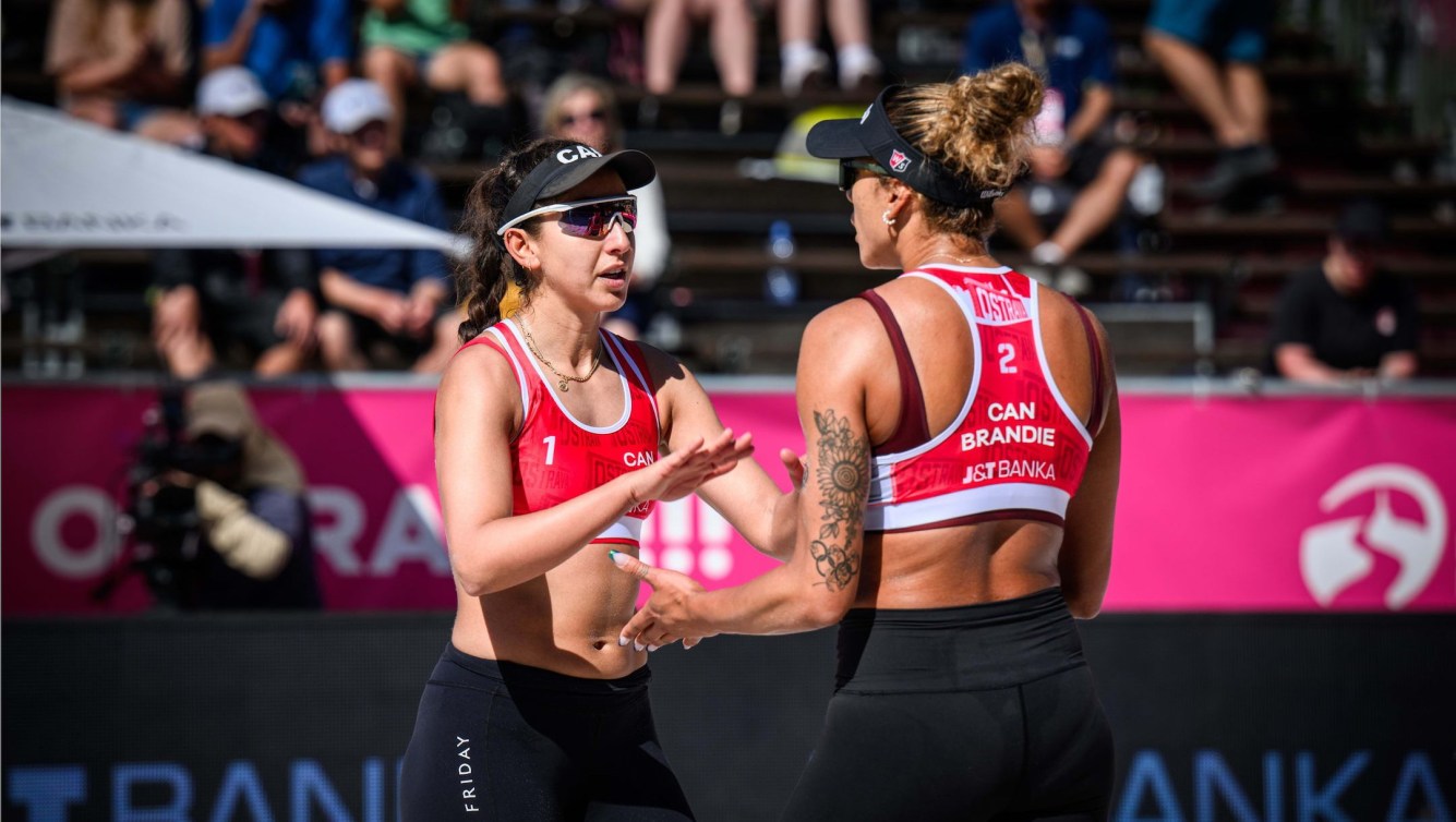 Pictured are Canadian beach volley ball players Melissa Humana-Paredes and Brandie Wilkerson high-fiving one-another.