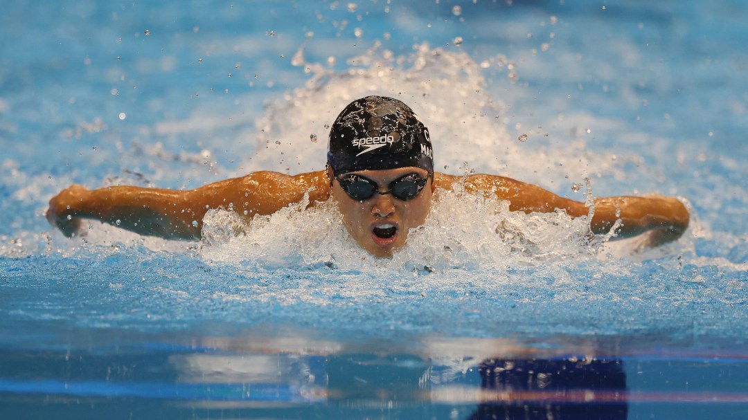 Maggie Mac Neil swims butterfly stroke directly towards the camera