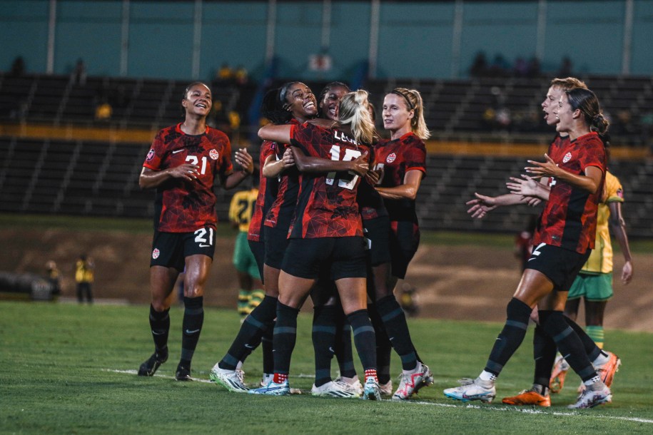 Canada players celebrate after scoring a goal.