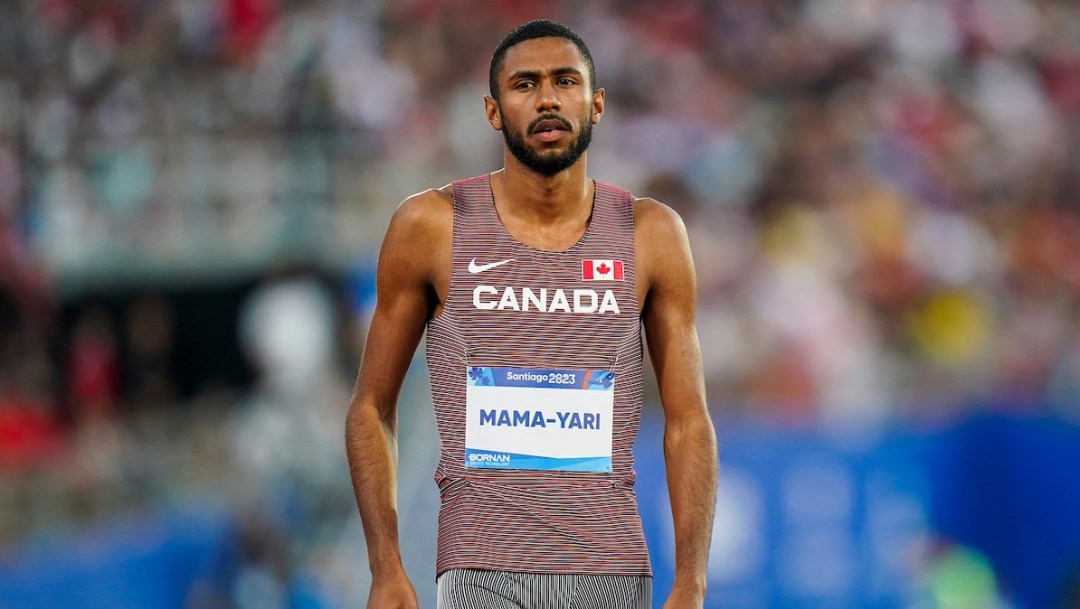 Zakary Mama-Yari stands on the track wearing a Team Canada kit