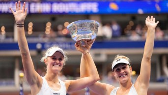 Erin Routliffe, of New Zealand, left, and Gabriela Dabrowski, of Canada, hold up the championship trophy after winning the women's doubles final of the U.S. Open.