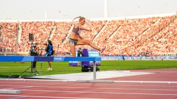 Kiana Gibson hurdles over a barrier