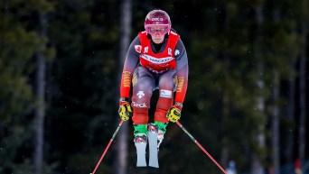 A female ski cross racer jumps for Team Canada