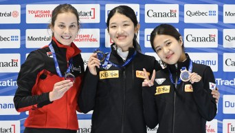 Seo Whimin of South Korea, centre, Danae Blais of Canada, left, and Park Jiyun of South Korea hold up their medals following the 1000-metre final race at the World Cup Short Track Speedskating event in Montreal, Sunday, Oct. 29, 2023. THE CANADIAN PRESS/Graham Hughes