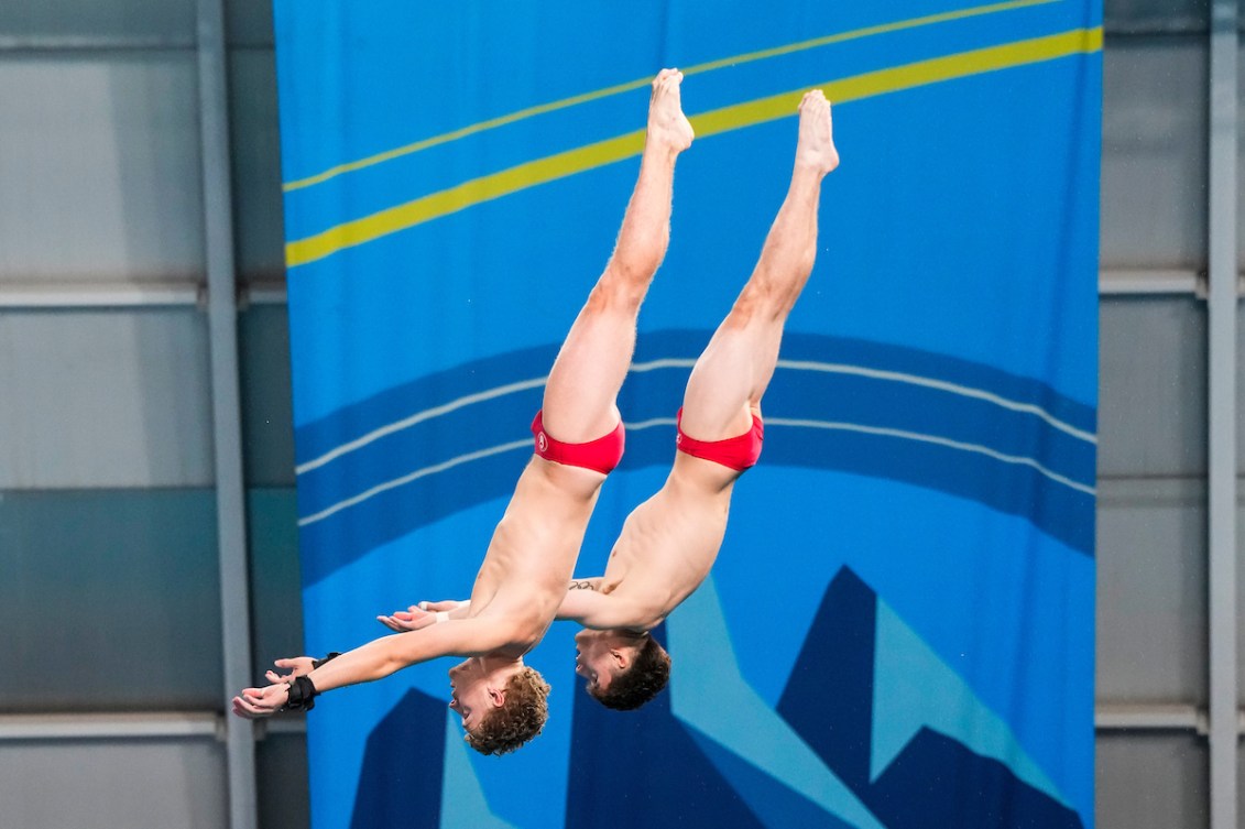 Rylan Wiens and Nathan Zsombor-Murray are in sync as they are inverted mid air