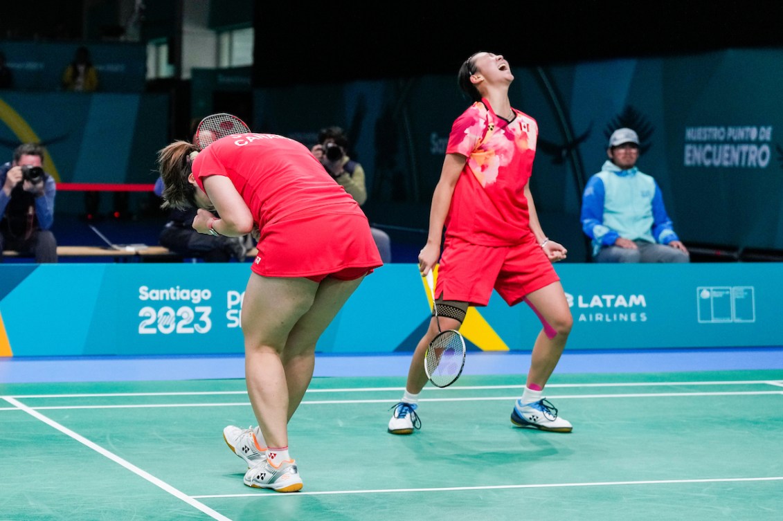 Catherine Choi screams with excitement after winning the gold medal in badminton doubles with partner Josephine Wu who bends over and pumps her fist