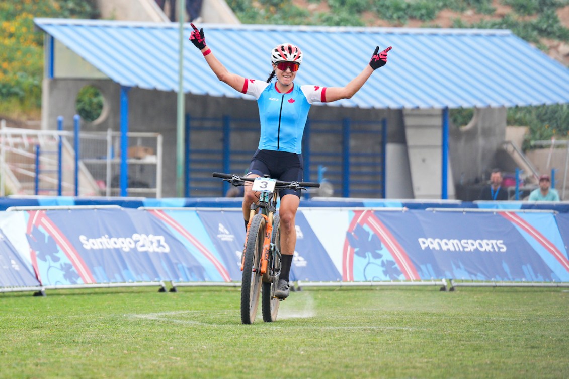 Jennifer Jackson of Canada celebrates as she crosses the finish line to win the gold medal in the Women’s Mountain Bike Cross Country event during the Santiago 2023 Pan American Games